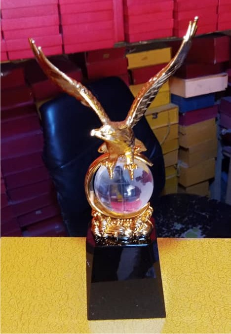 Gold medal-style plaque with decorative black base